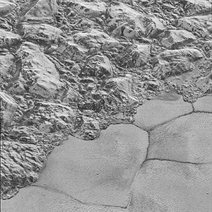 Mountains of ice along a portion of smoother ice planes on Pluto's surface.